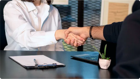 Two people shaking hands and cooperating